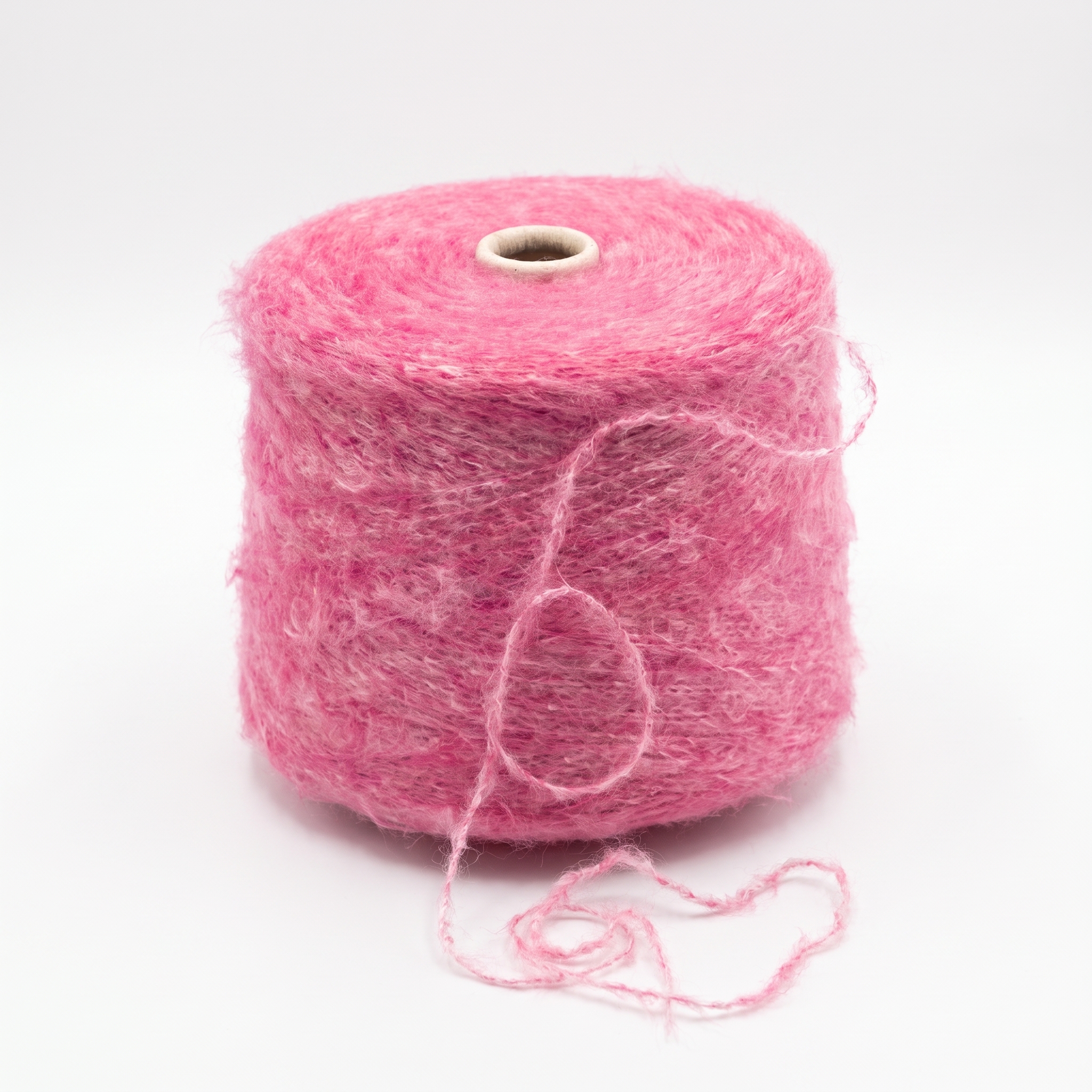 En stor spole med loddent, rosa garn.