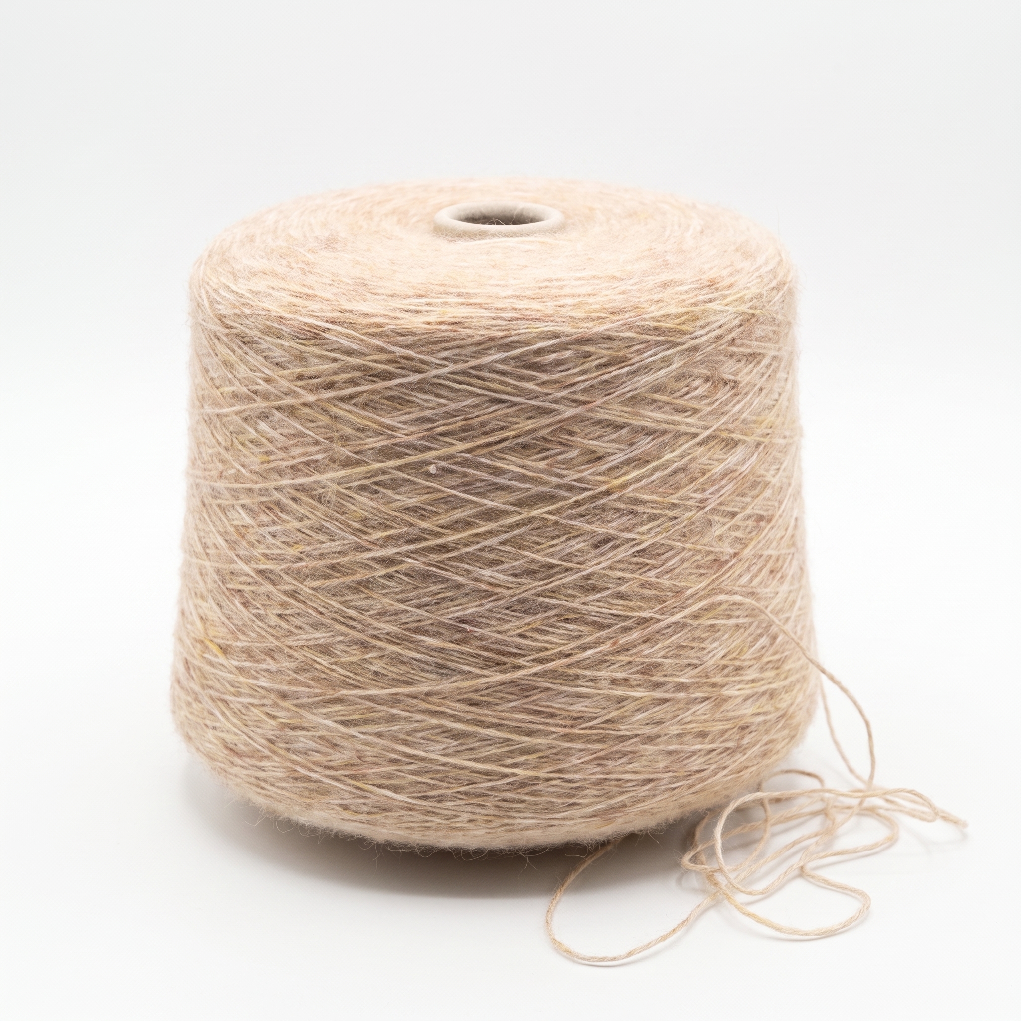 En stor spole med beige garn står på en hvit bakgrunn med en løs trådende ved foten.