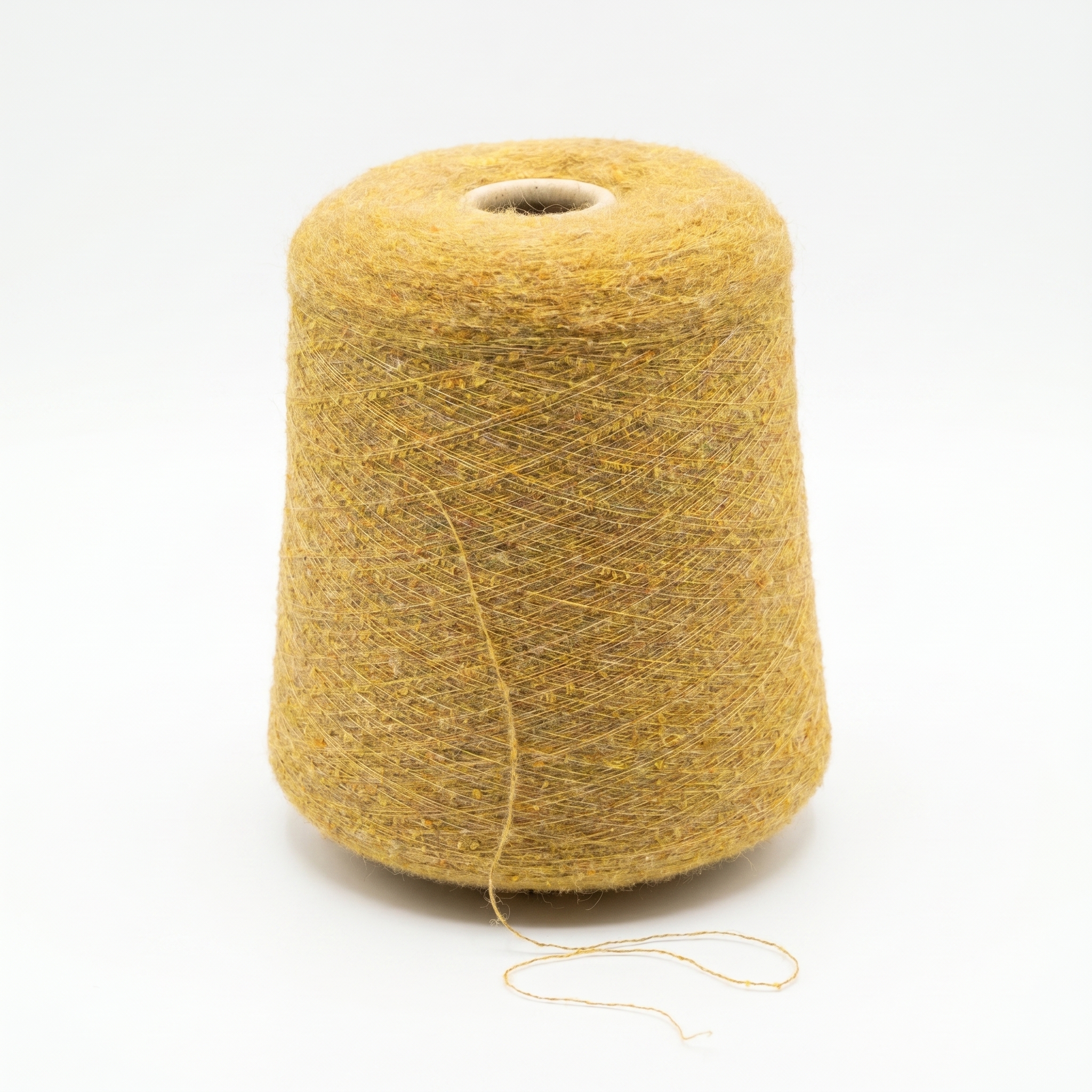 En stor spole med sennepsgult, tweed-lignende garn på en hvit bakgrunn.